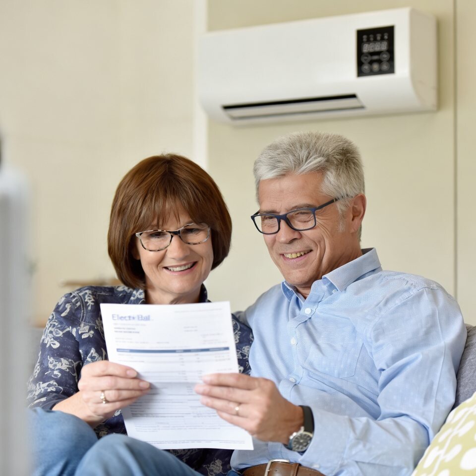 A couple reviewing their energy bill at home